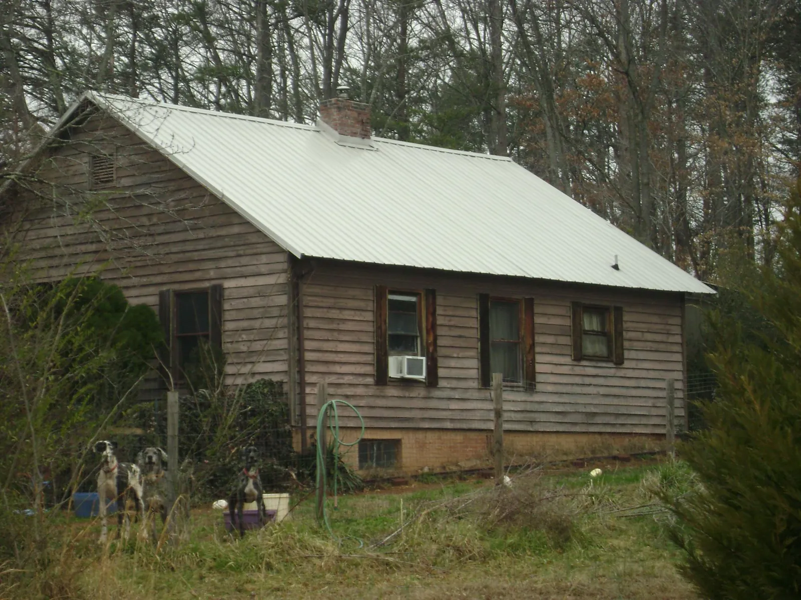 White metal roof on an old wood sided farmhouse, from a Metal Roof Installation job in Tappahannock